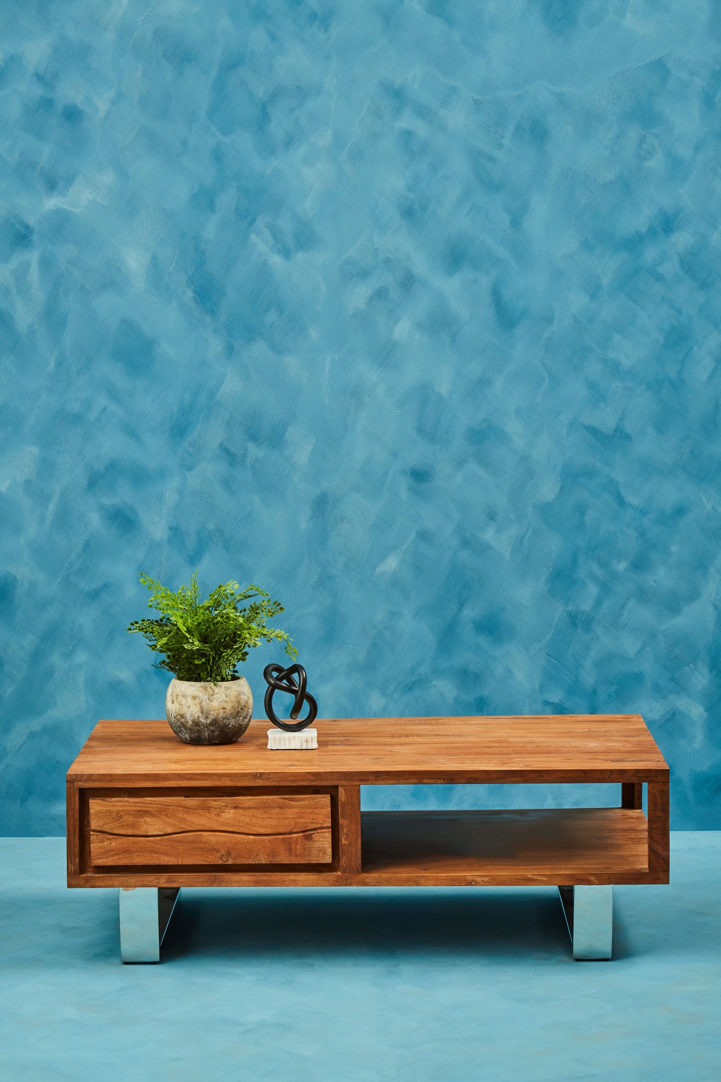 Coffee table is made with strong accacia wood and supported by sturdy metal legs