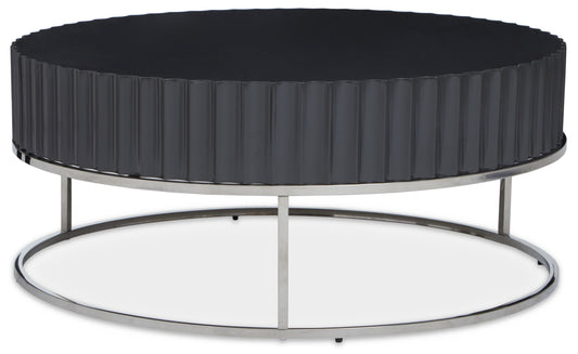 Coffee table features a flat top with fluted carvings in a grey finish and airy polished stainless steel frame.